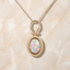 Bezel-Set Oval Opal Pendant with Beaded Border